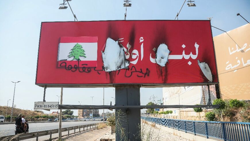 Signs reading 'Lebanon first' were burned along Beirut's airport road