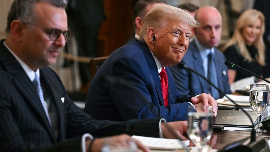 US President Donald Trump, flanked by US Senior Advisor for Africa Massad Boulo and White House Deputy Chief of Staff Stephen Miller, participates in a multilateral lunch with visiting African Leaders in the State Dining Room of the White House
