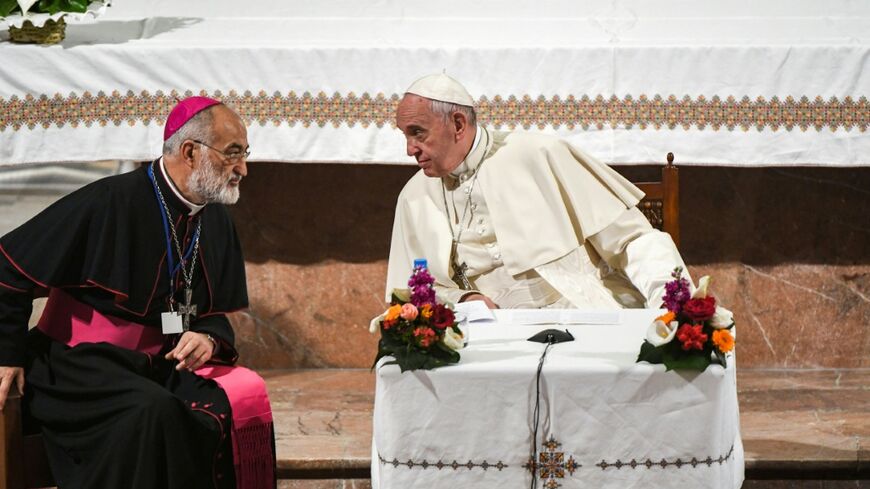 Pope Francis speaks with the Cardinal Cristobal Lopez Romero (left) during his papal visit to Morocco in 2019