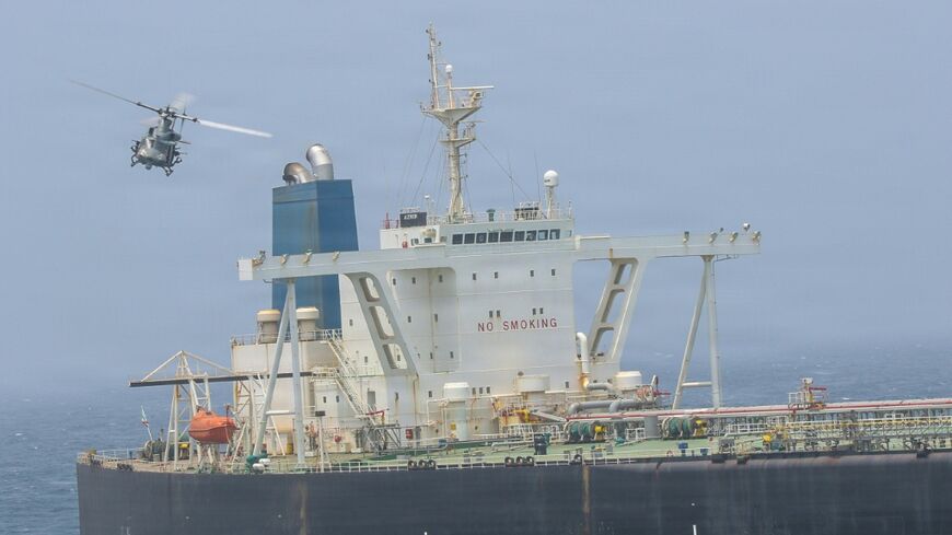 A US Marine Corps handout showing Marines boarding a ship, M/T Wen Yao, in the Gulf of Oman on Thursday as part of America's revived blockade of Iranian ports