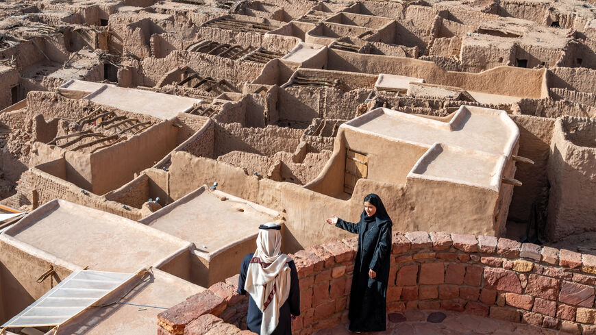 A Rawi with a visitor in AlUla’s old town, photo displayed at UNESCO’s headquarters in Paris, France. (Photo by Nick Jackson).