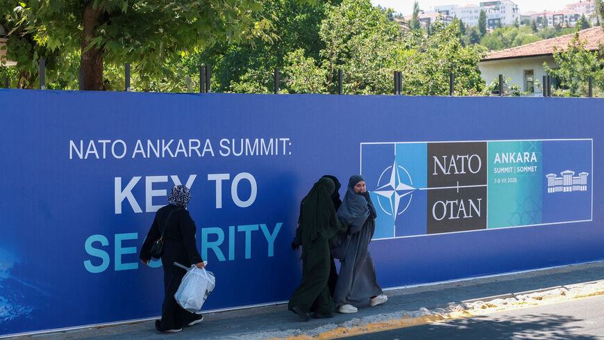 People walk past billboards built for upcoming NATO summit in Ankara, Turkey, July 1, 2026. REUTERS/Efekan Akyuz
