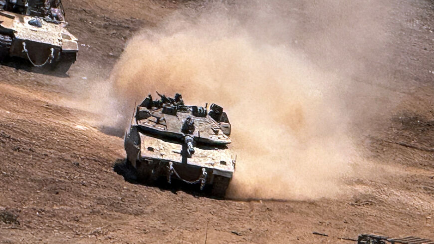 An Israeli tank and an APC maneuver on the Israeli side of the Israel-Lebanon border, after crossing the border into Israel, July 1, 2026. Picture taken with a mobile phone. REUTERS/Avi Ohayon