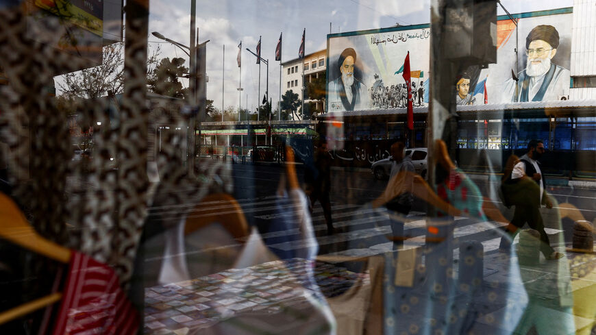 A mural depicting the late leader of the Islamic Revolution, Ayatollah Ruhollah Khomeini, and the late Iran's Supreme Leader Ayatollah Ali Khamenei, is reflected on a window display of a shop, amid the U.S.-Israeli conflict with Iran, in Tehran, Iran, March 22, 2026. Majid Asgaripour/WANA (West Asia News Agency) via REUTERS