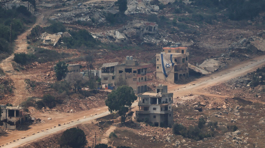 FILE PHOTO: An Israeli flag hangs from a building in Lebanon as seen from the Israeli side of the Israel-Lebanon border, in northern Israel, July 5, 2026. REUTERS/Shir Torem/File Photo