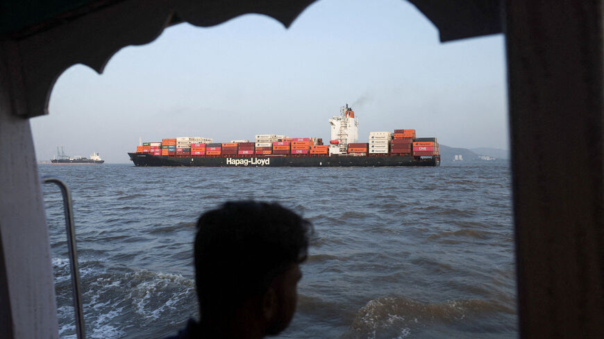 FILE PHOTO: A man looks at a container ship in the Arabian Sea off the coast of Mumbai, India, May 6, 2026. REUTERS/Francis Mascarenhas/File Photo