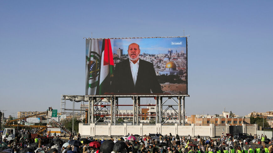 Protesters, mainly Houthi supporters, stand near a screen displaying Senior Hamas official Khalil al-Hayya during a rally to show support to Lebanon's Hezbollah and Palestinians in the Gaza Strip, in Sanaa, Yemen October 18, 2024. REUTERS/Khaled Abdullah