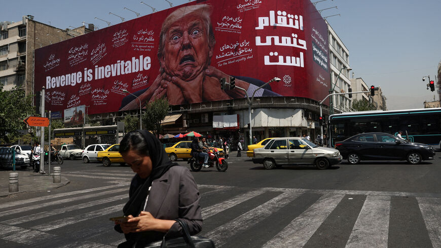 A woman walks near a billboard depicting U.S. President Donald Trump on a building in Tehran, Iran, July 27, 2026. Majid Asgaripour/WANA (West Asia News Agency) via REUTERS