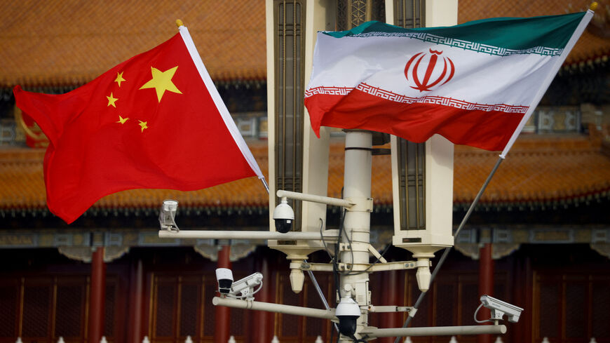 FILE PHOTO: The national flags of China and Iran fly in Tiananmen Square, China, February 14, 2023. REUTERS/Thomas Peter/File Photo