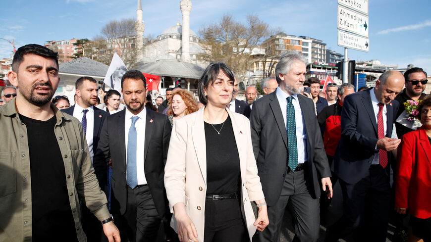 FILE PHOTO: Newly elected Uskudar Mayor Sinem Dedetas, accompanied by her husband Baris Dedetas, walks at Uskudar Square after receiving her mayoral certificate, in Istanbul, Turkey April 4, 2024. REUTERS/Dilara Senkaya/File Photo