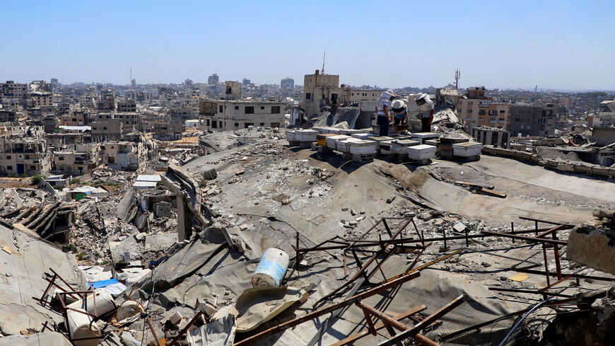 Palestinian beekeepers work on beehives installed on top of a ruined building, amid widespread destruction and a shortage of space, in Gaza City, June 25, 2026. REUTERS/Ebrahim Hajjaj