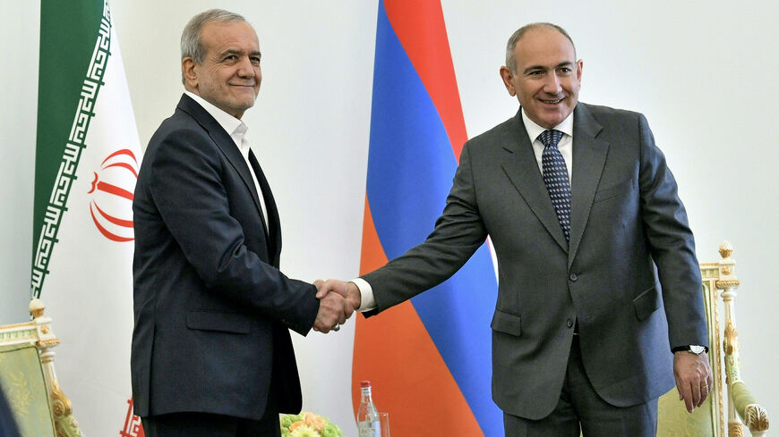 Armenia's Prime Minister Nikol Pashinyan (R) shakes hands with Iran's President Masoud Pezeshkian during his visit in Yerevan on July 19, 2025. (Photo by KAREN MINASYAN / AFP) (Photo by KAREN MINASYAN/AFP via Getty Images)