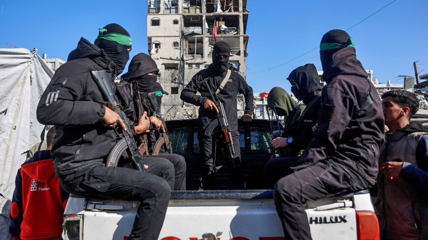 Palestinian Hamas militants arrive to secure the area as Egyptian workers accompanied by members of the International Committee of the Red Cross (ICRC), search for the last two remaining bodies of hostages -an Israeli soldier and a Thai national- from under the rubble of the Jabalia refugee camp, in the northern of Gaza Strip on Dec. 1, 2025.