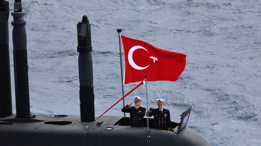Turkey's servicemen stand at attention on a Turkish submarine as they participate in the live-fire phase of the Blue Homeland 2026  tactical military exercises in the eastern Mediterranean Sea, in Antalya on April 9, 2026. 