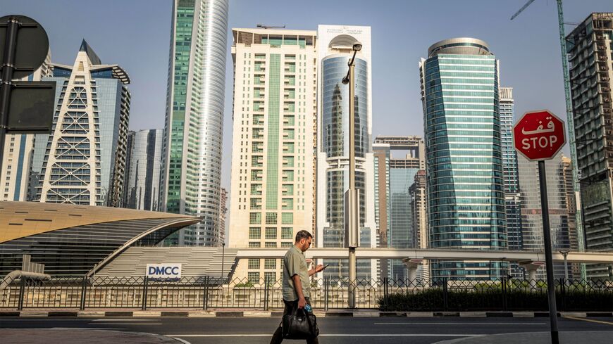A man crosses a street while returning home from work, in Dubai on June 23, 2026. (Photo by FADEL SENNA / AFP via Getty Images)