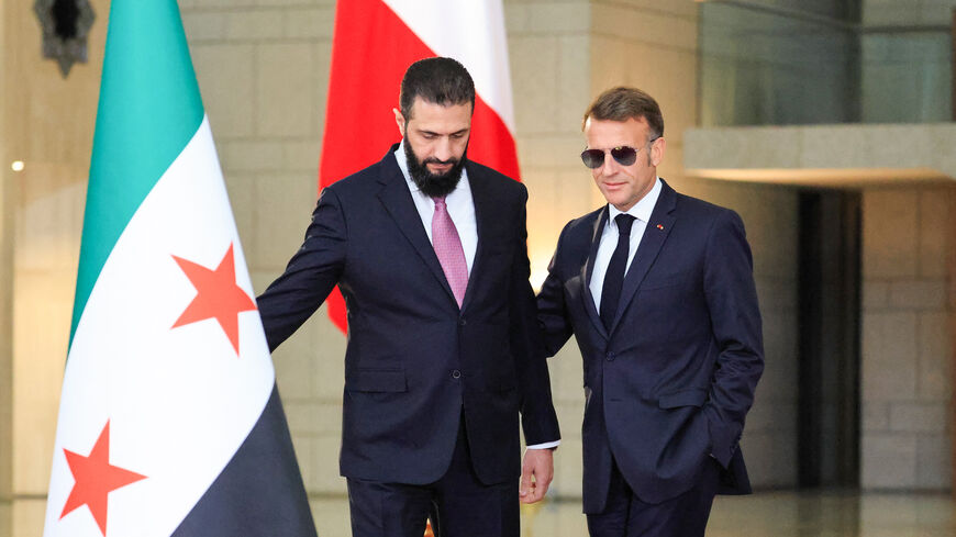 Syrian President Ahmed al-Sharaa (L) welcomes France's President Emmanuel Macron for a joint press conference in Damascus on July 7, 2026. 