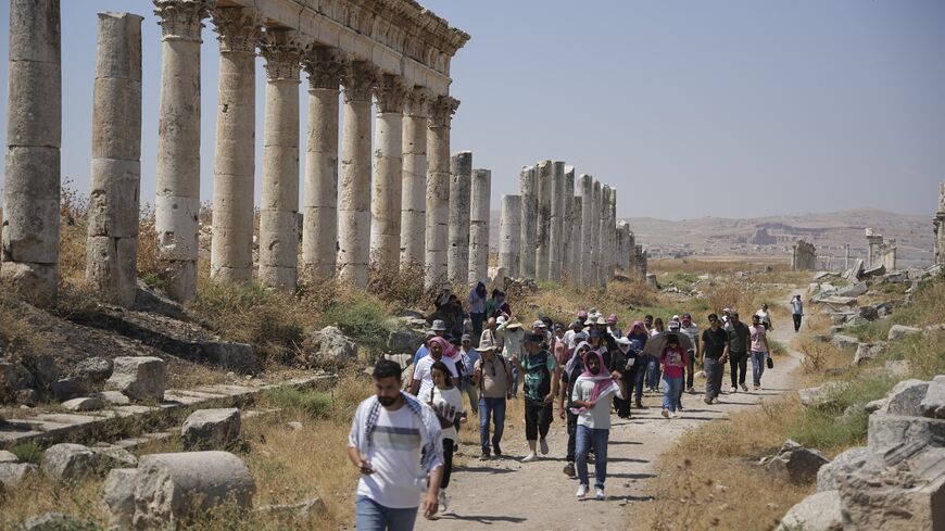 Tourism students and visitors visit the ruins of the ancient city of Apamea in the Hama countryside, Syria, on July 8, 2026. 