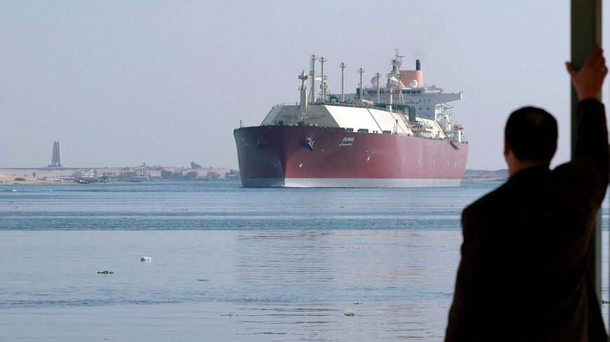 An Egyptian man looks at the Qatari Liquefied Natural Gas (LNG) carrier "Duhail" as its passes through the Suez Canal near the Egyptian port city of Ismailia on April 1, 2008. The vessel has a capacity of 210,100 cu.m making it one of the largest LNG carriers constructed to date. AFP PHOTO/STR (Photo credit should read -/AFP via Getty Images)