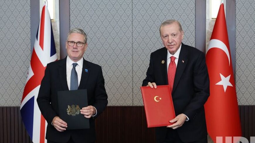 Britain's Prime Minister Keir Starmer (L) and Turkish President Recep Tayyip Erdogan pose after signing a defense partnership agreement on the sidelines of the NATO summit in Ankara, Turkey, Wednesday, July 8, 2026. 