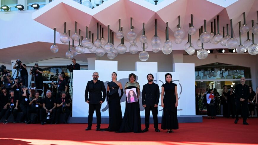 Actors and the director pose with a portrait of late Palestinian girl Hind Rajab during the red carpet for the movie "The Voice of Hind Rajab" at the 82nd International Venice Film Festival on September 3, 2025