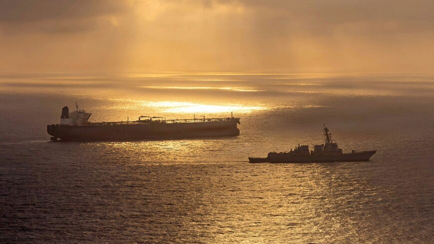 This US Navy handout photo released on May 8 shows the Arleigh Burke-class guided-missile destroyer USS Rafael Peralta (DDG 115) implementing a maritime blockade against the Iran-flagged crude oil tanker vessel Herby