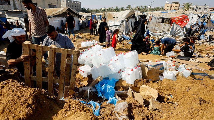 Palestinians inspect the site of an overnight Israeli strike on a medicine warehouse, according to medics, next to tents sheltering displaced Palestinians, in Deir al-Balah, in the central Gaza Strip, August 1, 2026, displaced Palestinians sheltering in the nearby tents had been pre-warned by the Israeli military to evacuate. REUTERS/Mahmoud Issa