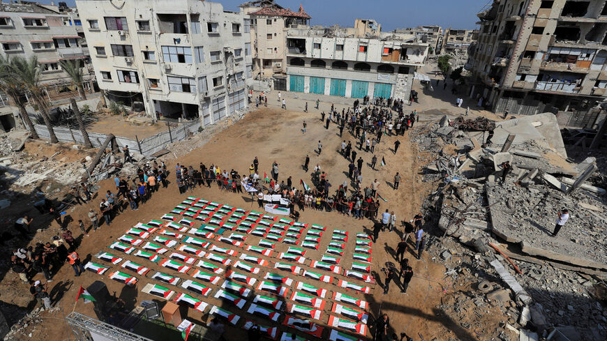 Palestinians attend the funeral of 112 members of the Hassayna and Abu Sharia clan, who were killed in an Israeli strike in 2023 and whose remains were recovered from beneath the rubble, according to Gaza's Civil Defense, in Gaza City, August 4, 2026. REUTERS/Dawoud Abu Alkas     TPX IMAGES OF THE DAY