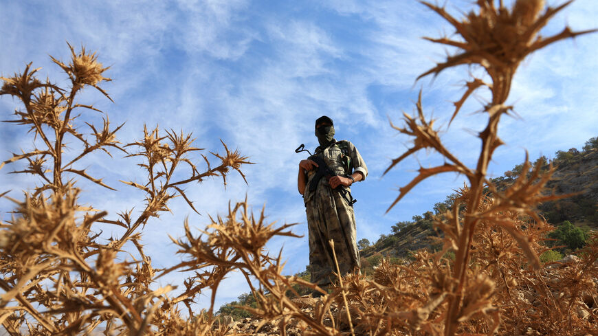 FILE PHOTO: A fighter with the Kurdistan Workers' Party (PKK) stands guard in the Qandil mountains, Iraq, October 26, 2025. REUTERS/Thaier Al-Sudani/ File Photo
