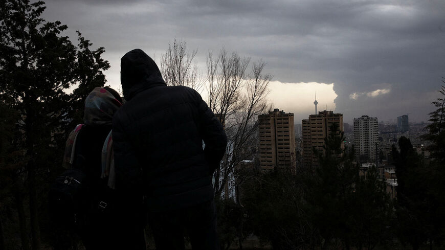 A picture taken by Yalda Moaiery, who received a 15 year prison sentence for her work as a journalist in Iran, shows people looking at smoke lingering following a strike carried out during the 40-day U.S.-Israeli conflict with Iran, in Tehran, Iran, March-April 2026. At the centre of Moaiery's case are images she took during the U.S.-Israeli airstrikes in Iran. Yalda Moaiery/Handout via REUTERS