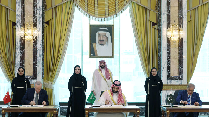 Turkish President Tayyip Erdogan, Saudi Crown Prince Mohammed bin Salman and Pakistan's Prime Minister Shehbaz Sharif sign a joint defense agreement in Mecca, Saudi Arabia, August 7, 2026. Murat Cetinmuhurdar/Turkish Presidential Press Office/Handout via REUTERS