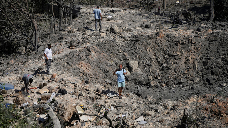 People and journalists stand at a site hit by Israeli strikes that occurred in the early hours of Thursday, according to Lebanon’s state news agency NNA, in Burj al-Shamali, southern Lebanon, August 6, 2026. REUTERS/Stringer     TPX IMAGES OF THE DAY