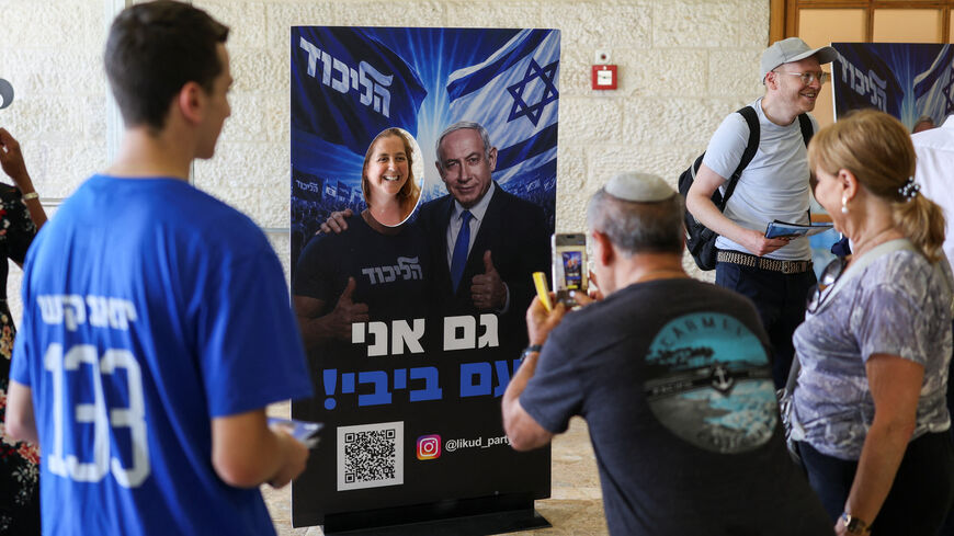 A woman poses with a photo stand-in featuring an image of Israeli Prime Minister Benjamin Netanyahu, on the day of the Likud party primaries list vote, ahead of Israel's general election in October, in Jerusalem, August 17, 2026. REUTERS/Ronen Zvulun