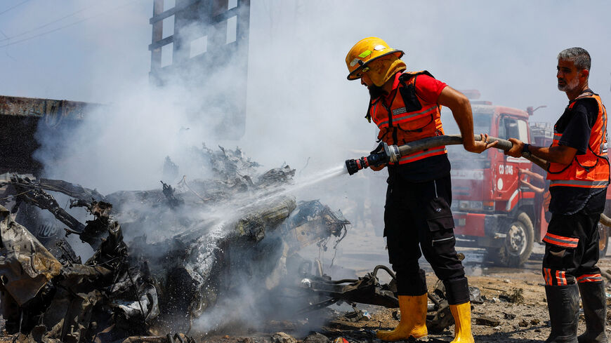 Palestinian Civil Defence firefighters work to extinguish a fire after an Israeli strike, carried out after the Israeli military warned residents to evacuate the area, Al-Zawayda, in the central Gaza Strip,  August 23, 2026. REUTERS/Mahmoud Issa