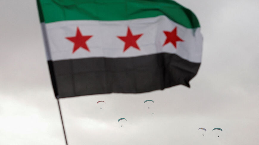 A flag flies in the wind at Ummayad Square in Damascus, Syria December 8, 2025. REUTERS/Yamam al Shaar