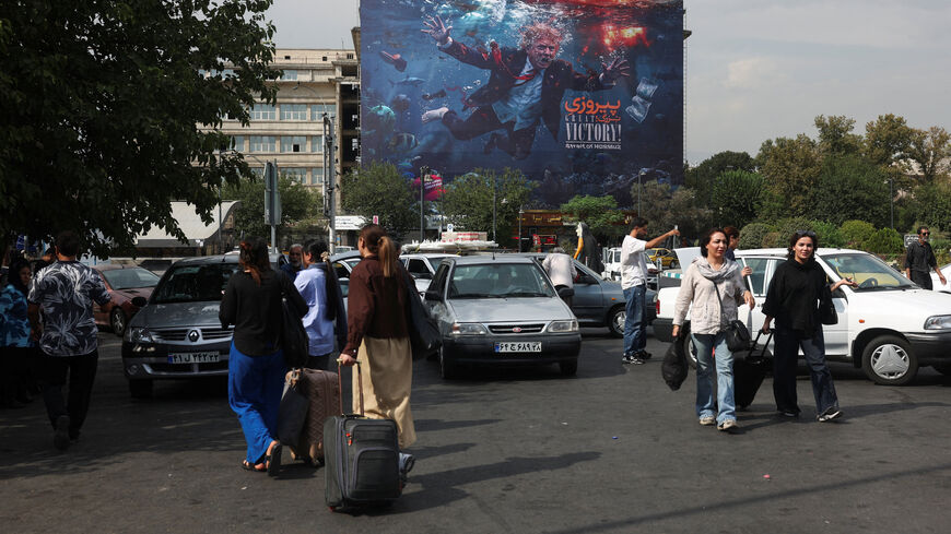 People walk near a billboard depicting U.S. President Donald Trump on a building in Tehran, Iran, August 22, 2026. Majid Asgaripour/WANA (West Asia News Agency) via REUTERS