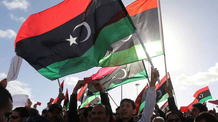 FILE PHOTO: People wave Libyan flags during a demonstration in Benghazi February 7, 2014.  REUTERS/Esam Omran Al-Fetori/File Photo