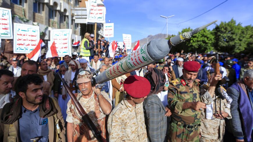 Supporters of Yemen's Houthi rebel movement carry a mock rocket as they demonstrate in the capital, Sanaa, to denounce a reported air strike by the Saudi-led coalition on a prison in the country's rebel-held north, on Jan. 21, 2022.