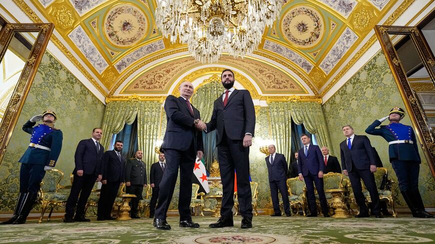 Russian President Vladimir Putin greets Syrian President Ahmed al-Sharaa at the Grand Kremlin Palace, Moscow, Oct. 15, 2025.