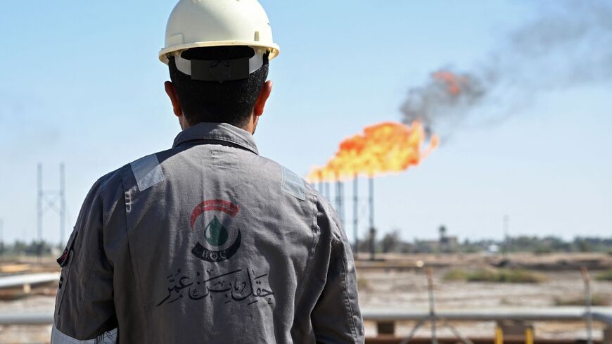 a worker inspects an oil field in Iraq