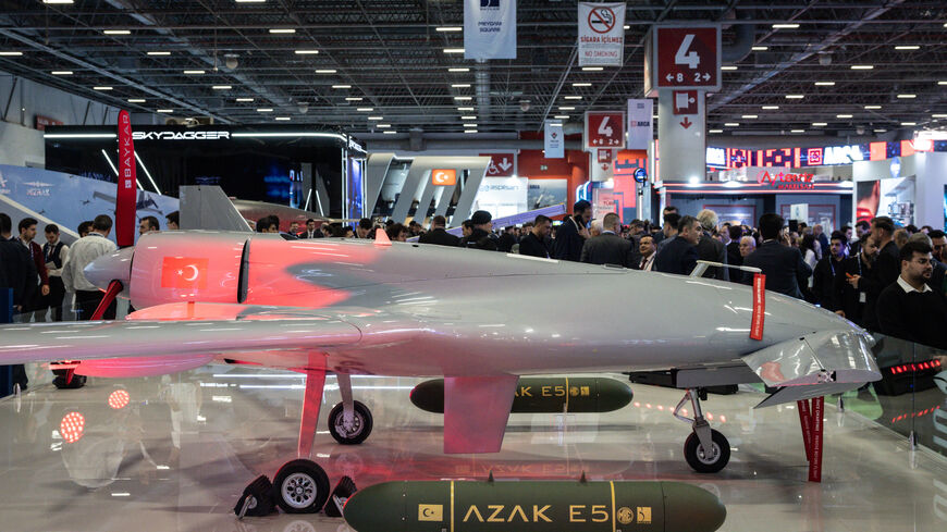 People look at a drone on display at the Baykar exhibit at the SAHA International Defense and Aerospace Expo on May 6, 2026 in Istanbul, Turkey. 