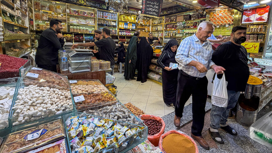 People shop at a store in the Grand Reza Bazaar near the shrine of Imam Reza following the funeral of slain Iranian leader Ali Khamenei and his family members in Mashhad on July 10, 2026. 