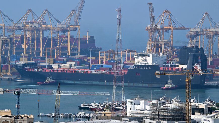 Ships are docked along a pier at the Khor Fakkan Container Terminal, the only natural deep-sea port in the region and one of the major container ports in Sharjah Emirate, along the Gulf of Oman on July 14, 2026. 