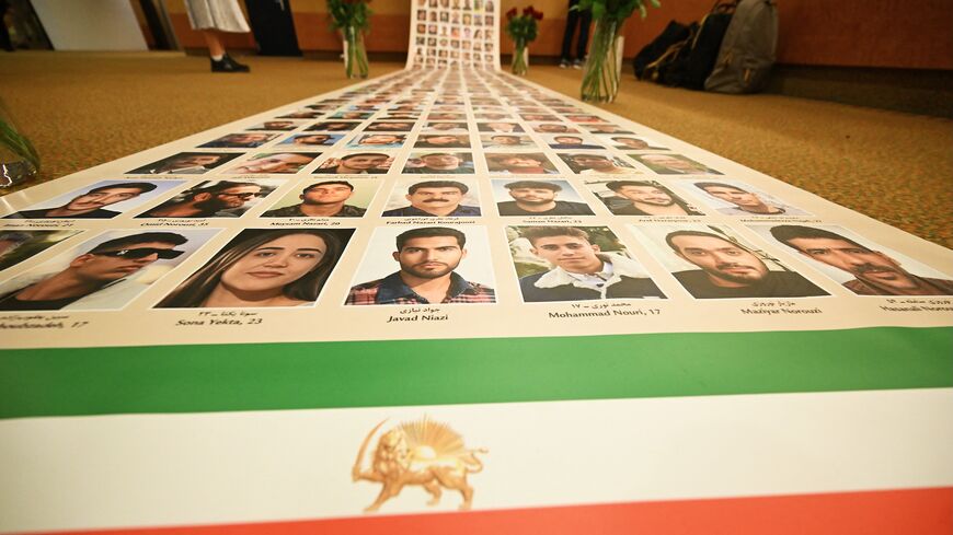 This photograph shows a banner featuring photos of Iranian protesters allegedly killed by the regime during a demonstration at the Ergife Palace Hotel to condemn the silence of Western governments in the face of the growing wave of Iranian political executions, in Rome, on July 16, 2026. 