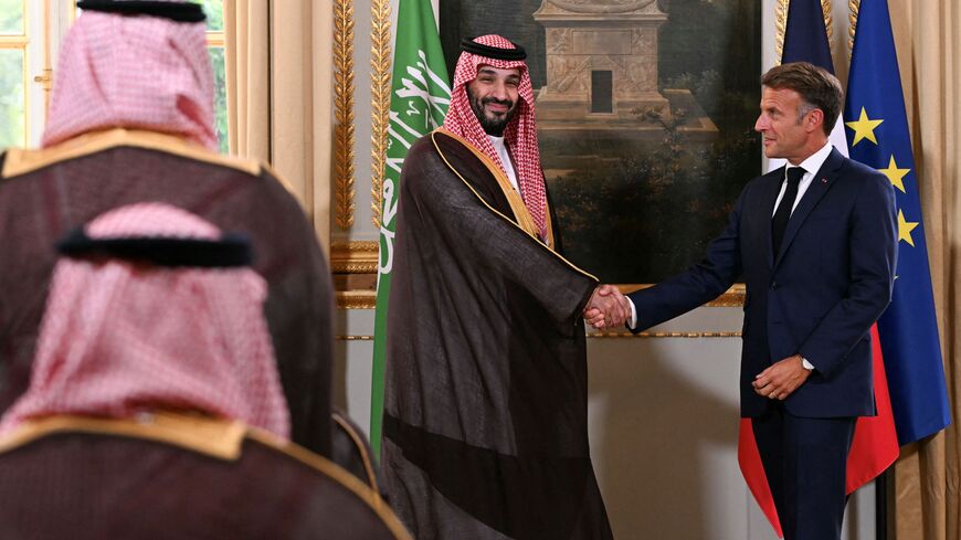France's President Emmanuel Macron and Saudi Arabia's Crown Prince Mohammed bin Salman shake hands