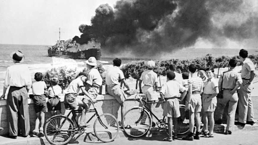 A merchant ship "Jabotinsky" (former "Altalena"), chartered by Jewish military group Irgun Zvaei Leumi to carry weapons for Israeli fighters, burns near Tel Aviv beach, after being shelled by the Haganah, Israel, June 27, 1948.