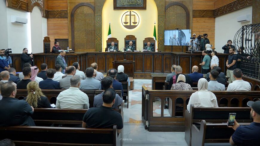 This handout picture released by the official Syrian Arab News Agency on Aug. 18, 2026, shows Judge Fakhr al-Din al-Aryan (C) during the sentencing of Wassim al-Assad.