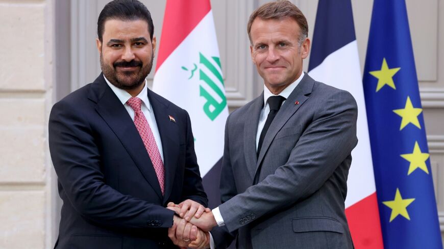 France's President Emmanuel Macron shook hands with Iraq's Prime Minister Ali al-Zaidi during the Iraqi leader's first visit to Europe since taking office in May