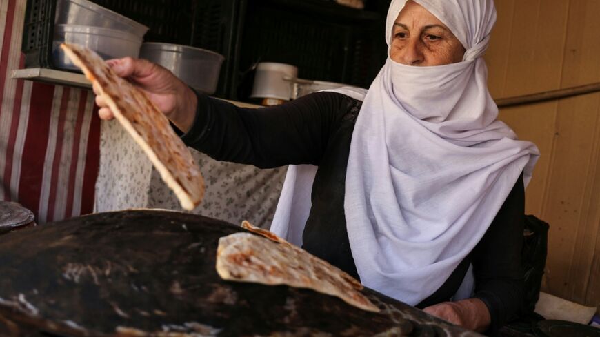 Hoda Kiwan bakes flatbread in the mainly Druze city of Sweida in southern Syria, but was one of many residents to complain that blocks on the road to government-controlled capital have left essential supplies like flour and oil in short supply