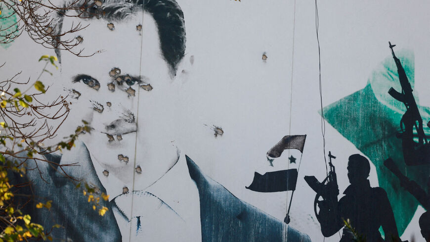 FILE PHOTO: A billboard with a picture of Syria's Bashar al-Assad shows damage by bullet holes, in Damascus, Syria, December 16, 2024. REUTERS/Ammar Awad/File Photo