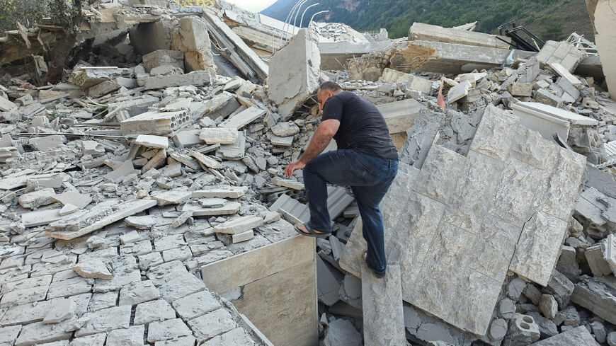 Resident Abbas Haidar makes way through rubble at the site of an Israeli strike, in Arab Salim, Lebanon, September 6 , 2026. Picture taken with a mobile phone. REUTERS/Ali Hankir